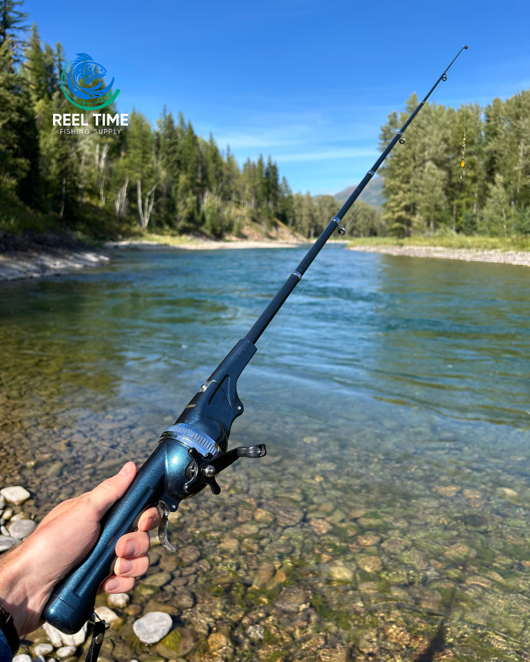 Angler holding a fully extended Foldable Travel Fishing Rod in front of a river.